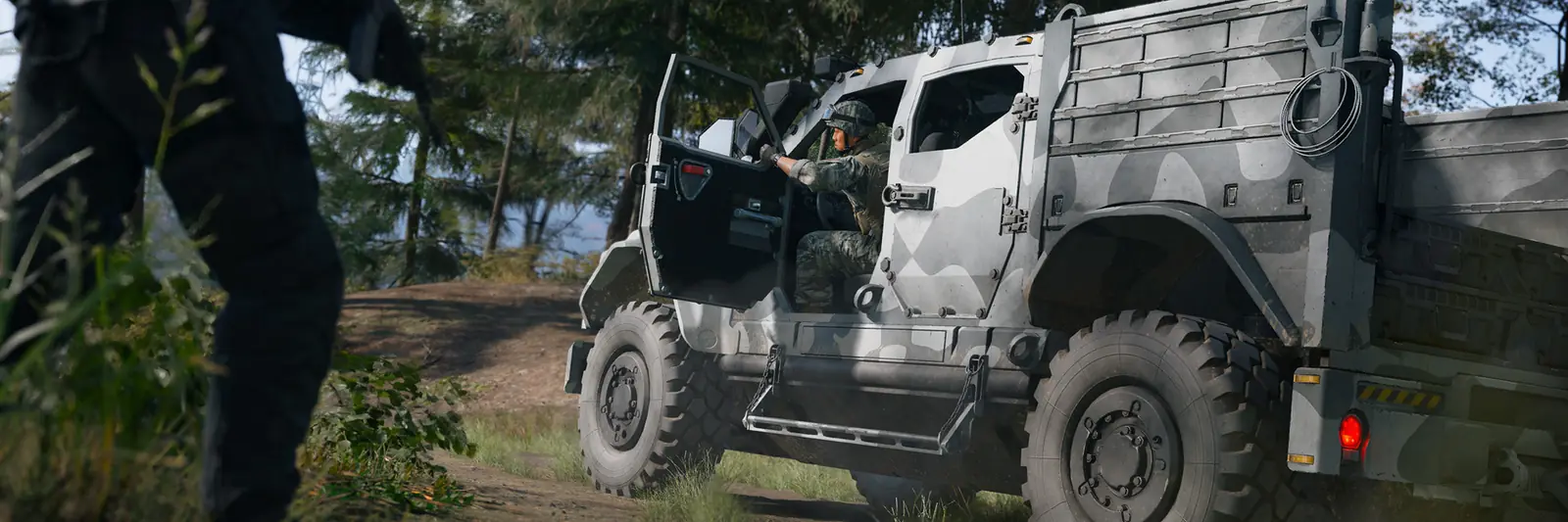 An Operator boarding a white camouflaged armored truck on a forest track in Hajin, MW4 DMZ
