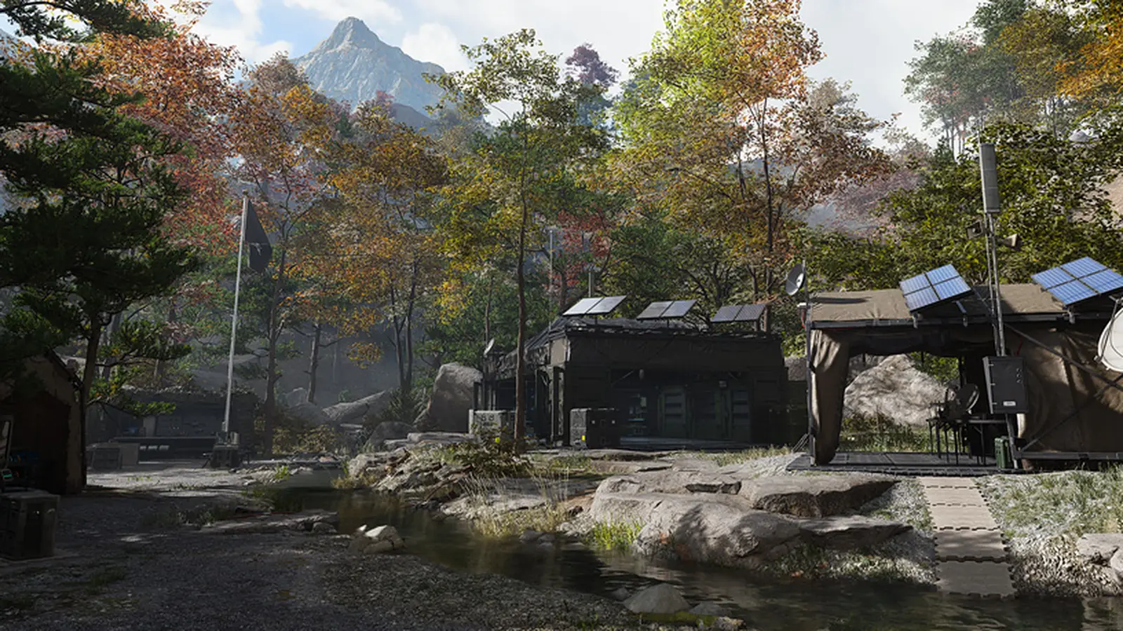 The Forward Operating Base in MW4 DMZ: tents with solar panels and a satellite dish in an autumn forest clearing below a mountain