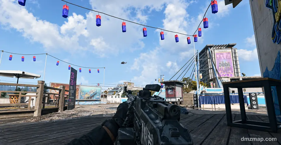 Red and blue lanterns strung over a wooden pier at Songdo Wharf, with a cable bridge, a hotel billboard and a helicopter in the sky, MW4 DMZ