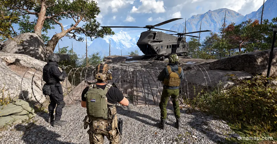 A squad of three Operators walking past coils of barbed wire toward a twin-rotor helicopter on a rock platform below snowy mountains, MW4 DMZ